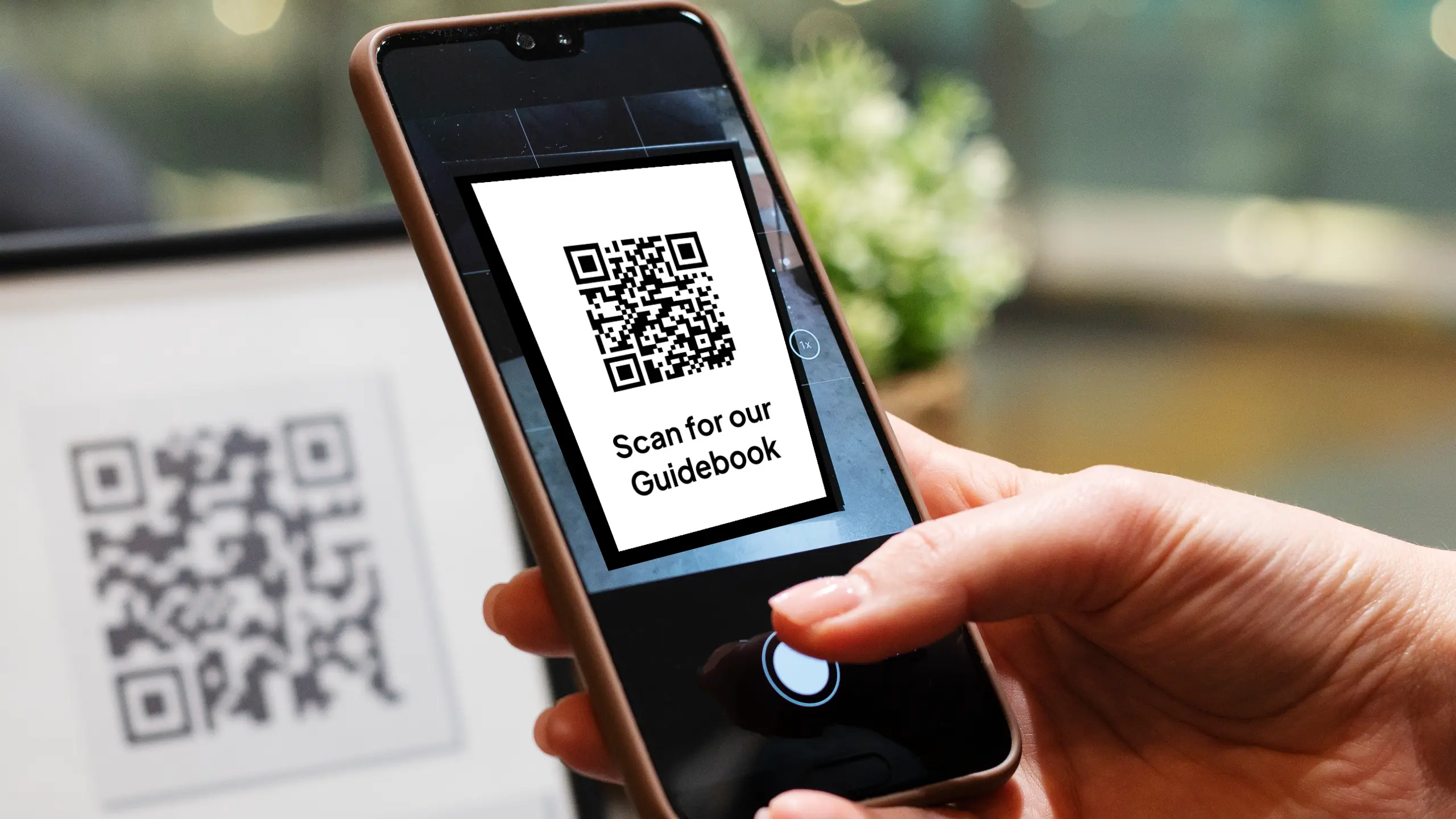 A guest scanning a QR code to access an InvoGuide guidebook